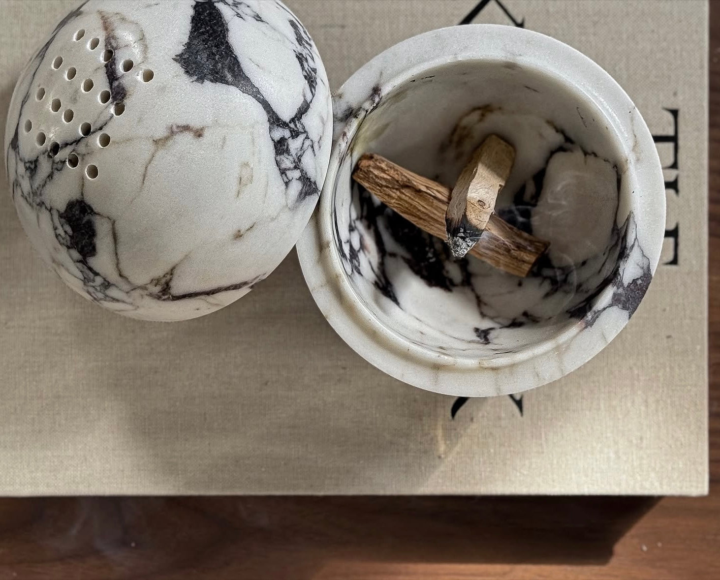 Globe incense holder in Calacatta Viola marble with purple veining
