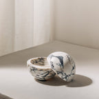 Globe incense holder in Calacatta Viola marble with purple veining
