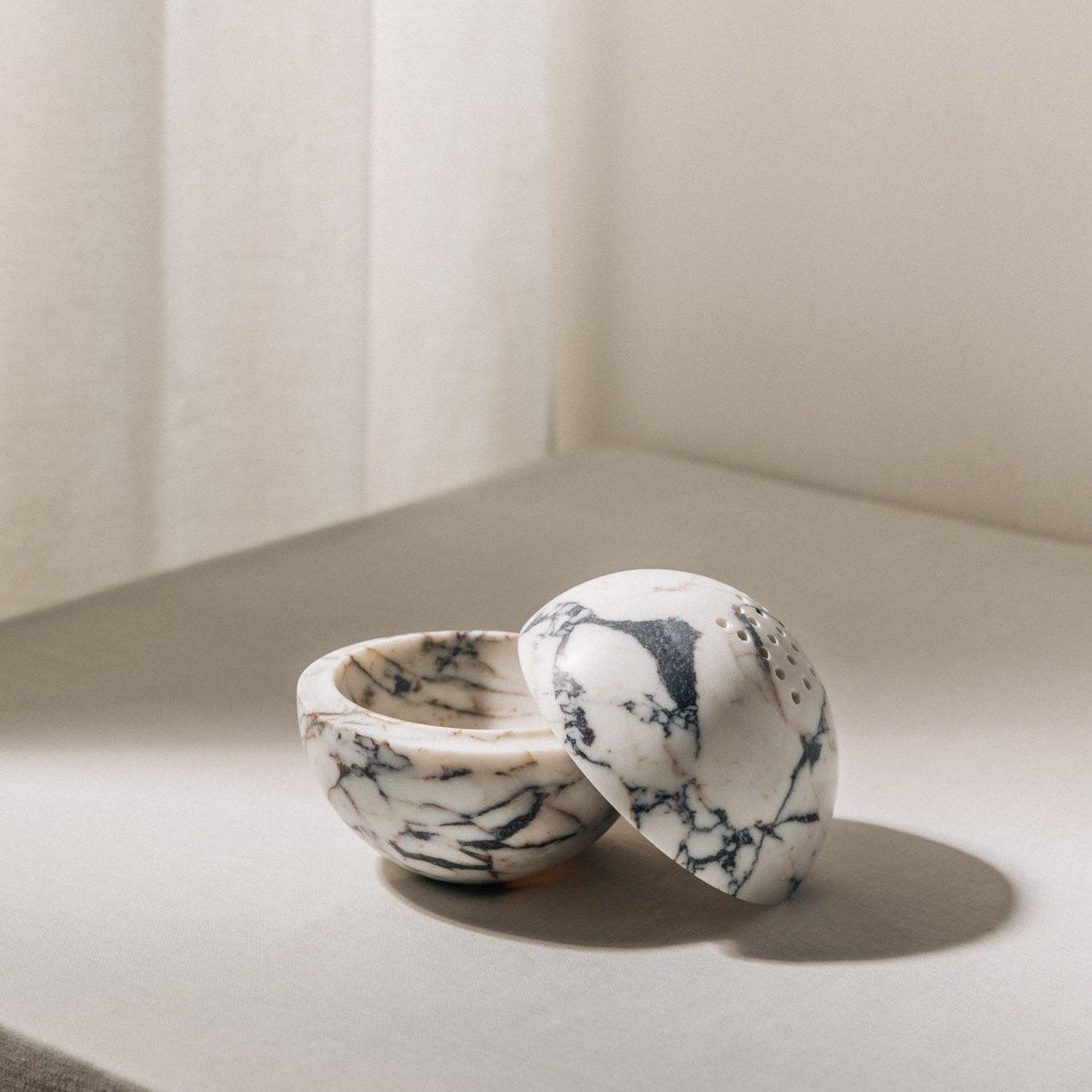 Globe incense holder in Calacatta Viola marble with purple veining
