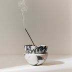 Globe incense holder in Calacatta Viola marble with purple veining
