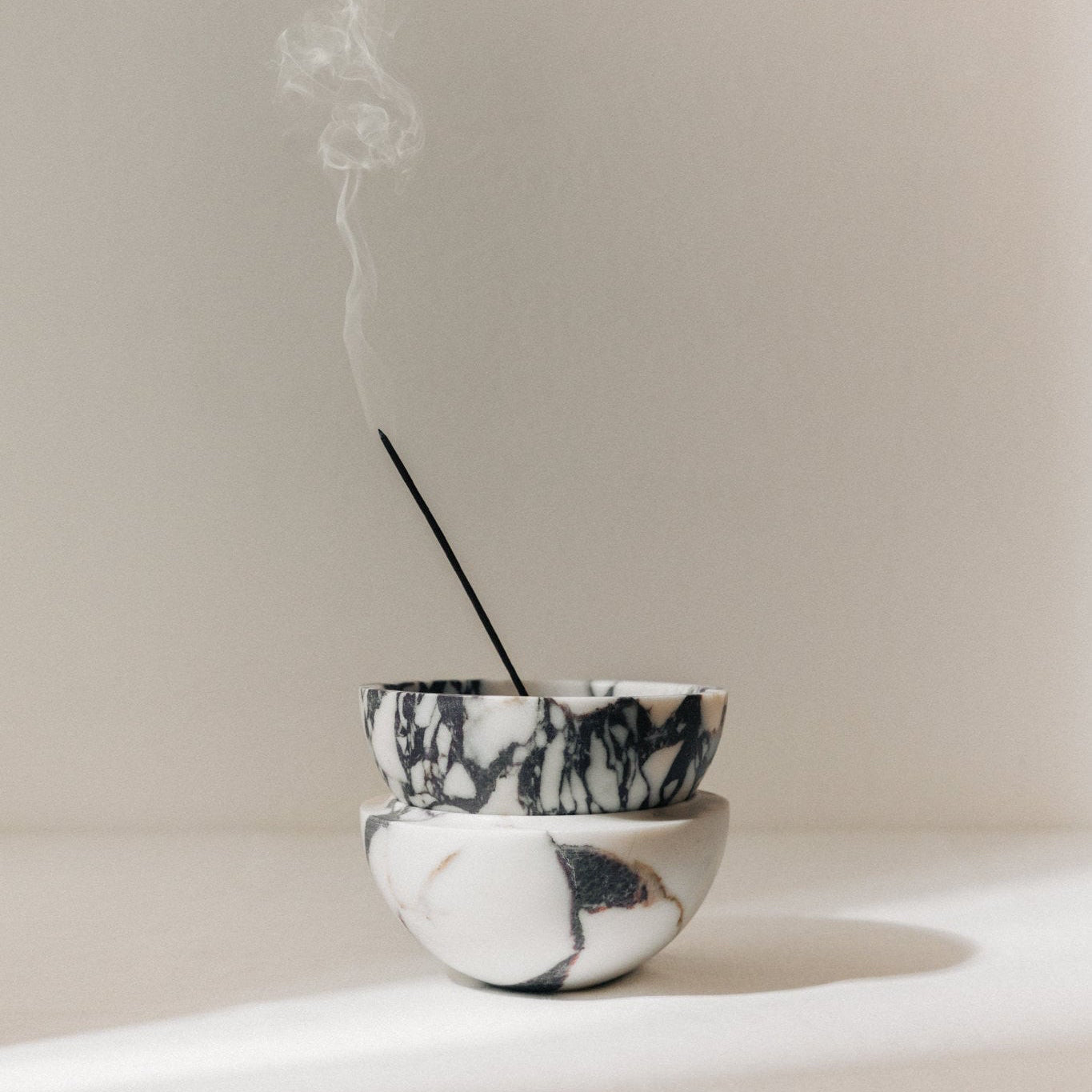 Globe incense holder in Calacatta Viola marble with purple veining
