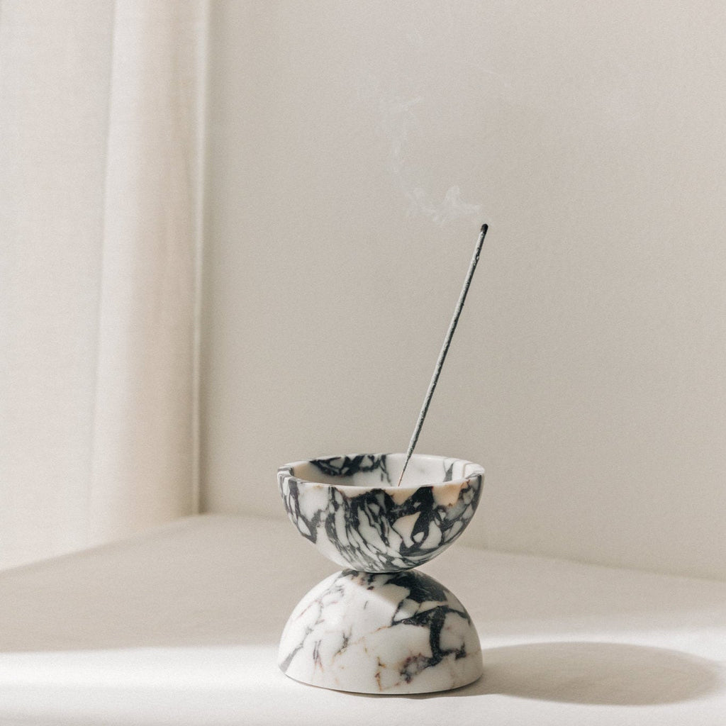 Globe incense holder in Calacatta Viola marble with purple veining
