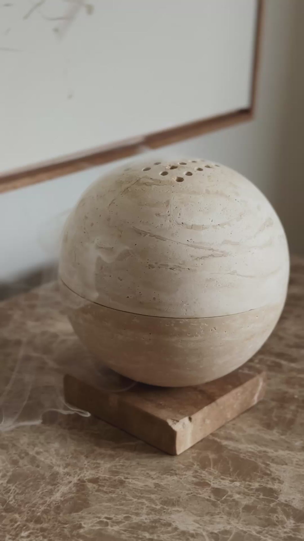 Globe incense sphere in beige travertine stone, PACU STUDIOS
